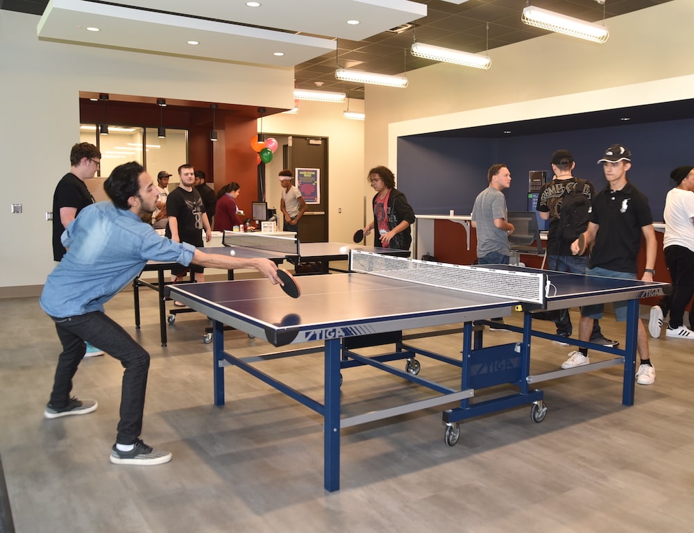 Students playing table tennis in the game room on South Campus