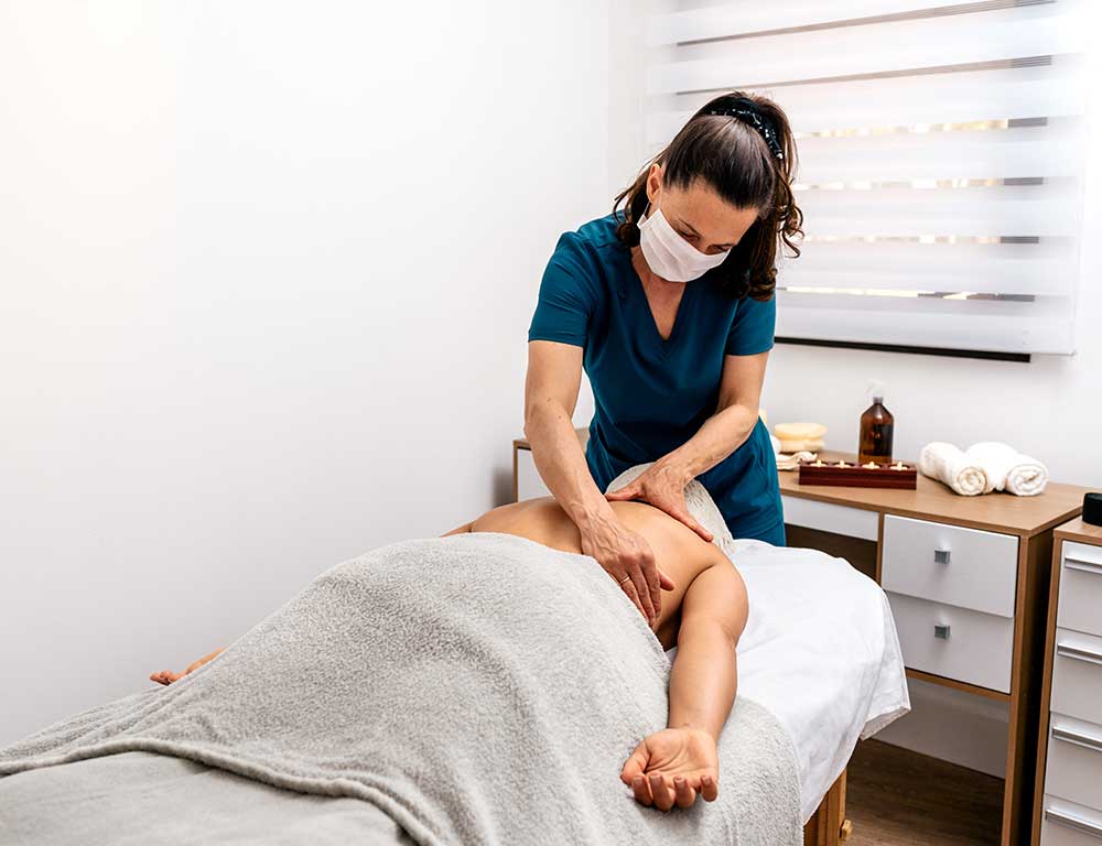 Massage Therapist working on client