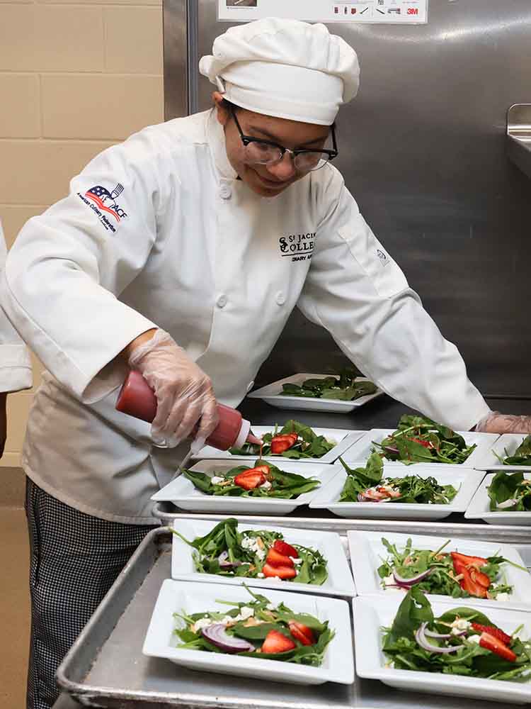 culinary student decorating salad