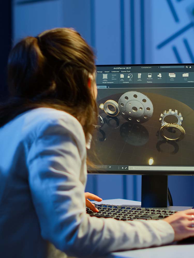 Woman at computer working on CAD drawing.