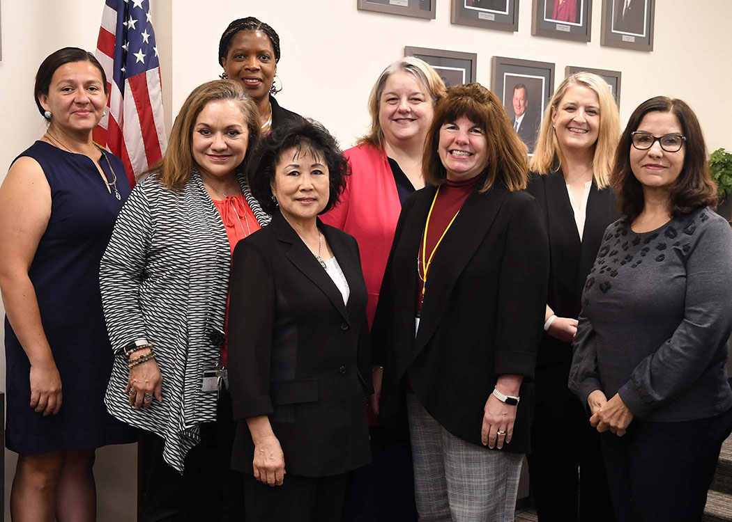 Group of eight women posing for photo